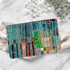May include: Abstract art print featuring a colourful mosaic of blue, green, red, and brown glass pieces. The mosaic is arranged in a geometric pattern, creating a modern and abstract design.