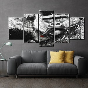 May include: A five-panel canvas art piece featuring a black and white gorilla smoking a cigar with a red tip. The artwork has a grunge style with paint splatter effects, creating a bold and striking visual.