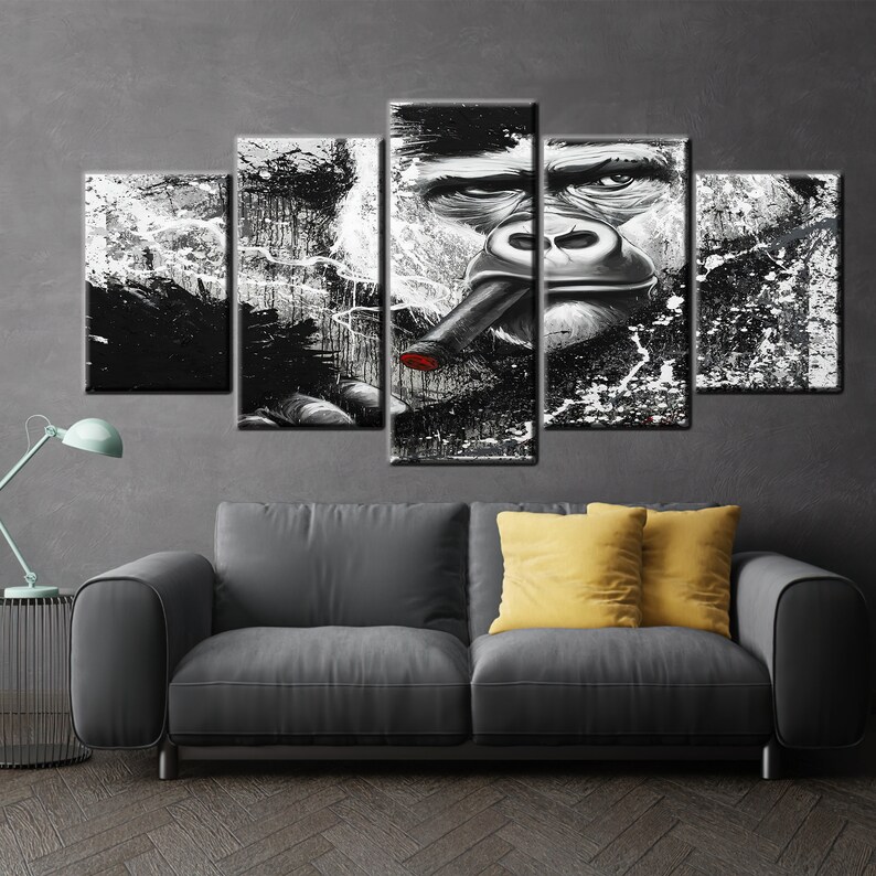 May include: A five-panel canvas art piece featuring a black and white gorilla smoking a cigar with a red tip. The artwork has a grunge style with paint splatter effects, creating a bold and striking visual.