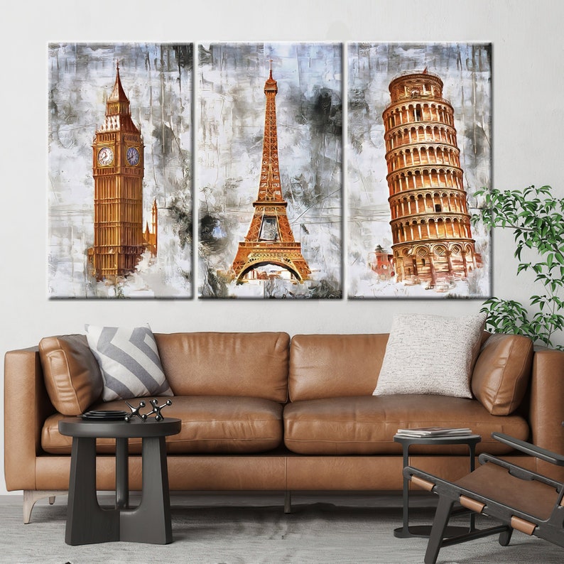 May include: Triptych canvas art featuring iconic landmarks: Big Ben, the Eiffel Tower, and the Leaning Tower of Pisa. The artwork has a watercolor effect with shades of gold, brown, and gray. The canvas is stretched and ready to hang.