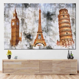May include: A large canvas print featuring iconic landmarks: Big Ben, the Eiffel Tower, and the Leaning Tower of Pisa. The artwork uses a textured, abstract style with a neutral color palette, creating a travel-themed decorative piece.