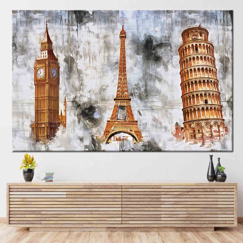 May include: A large canvas print featuring iconic landmarks: Big Ben, the Eiffel Tower, and the Leaning Tower of Pisa. The artwork uses a textured, abstract style with a neutral color palette, creating a travel-themed decorative piece.