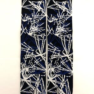 May include: Pair of black, blue, and white tabi socks. The socks feature a split-toe design and a pattern of white lines against a dark blue and black background. The cuffs are solid black.