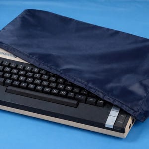 May include: A white ceramic mug with a black handle and the text "But First, Coffee" in a black, bold font. The mug is on a white surface.