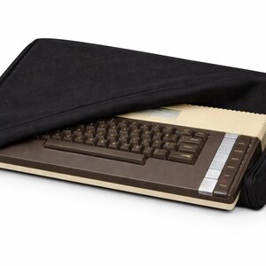 May include: A set of three ceramic mugs with a speckled, matte finish. The mugs are in shades of cream, light gray, and dark gray. Each mug has a simple, minimalist design and a rounded handle.