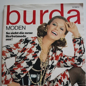 Könnte beinhalten: Ein Magazincover mit einer Frau, die eine Jacke und einen Rock im schwarz-weißen Hahnentrittmuster trägt. Das Magazin heißt "burda MODEN" und der Text "So sieht die neue Herbstmode aus!" ist sichtbar. Das Magazincover ist datiert auf September 1968.