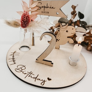 Pu&ograve; includere: Decorazione per compleanno in legno con un unicorno, il numero due, un piccolo vaso con fiori secchi, una candela e il testo "Happy Birthday" e "Sophie 04.09.2016".