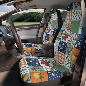 May include: A pair of car seat covers with a patchwork design featuring strawberries, lemons, and flowers. The covers are made of a soft, comfortable fabric and are easy to install.