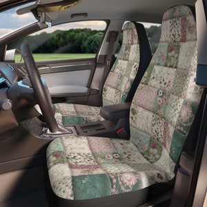 May include: Two car seat covers with a patchwork design featuring floral patterns in shades of pink, green, and cream. The covers are made of a soft, quilted fabric.