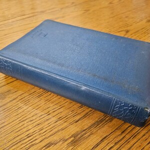 May include: A blue hardcover book with a decorative design on the spine.