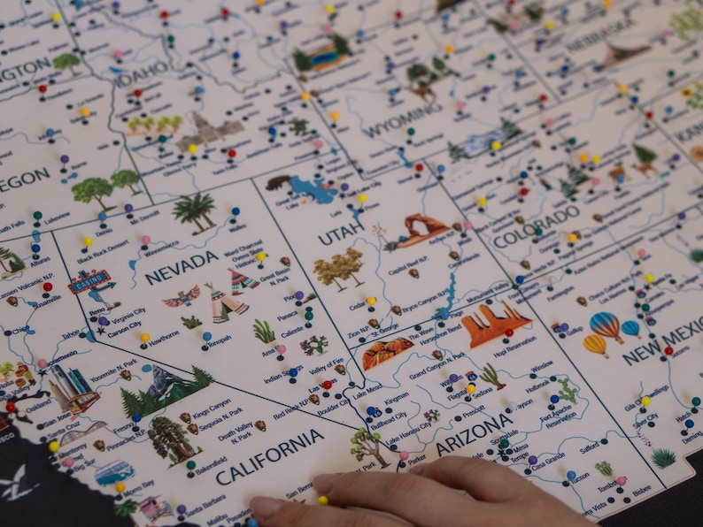 Close-up of Western USA travel map with push pins marking landmarks in Nevada, California, Utah, and Colorado. Interactive, customizable travel map with national parks, perfect for documenting adventures and decorating your home