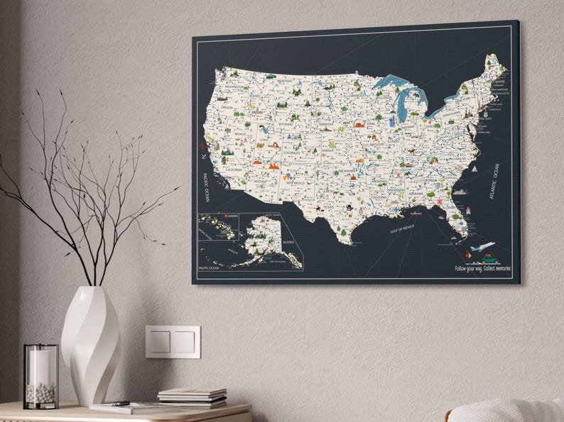 USA Travel Map, illustrated with top attractions for each state, hanged on a wall. The USA map is printed on canvas, the background is charcoal, while the land is light beige. In the right corner of the USA Map it is a personalization.