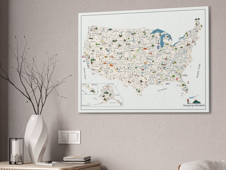 USA Travel Map, illustrated with top attractions for each state, hanged on a wall. The USA map is printed on canvas, the background is off white, while the land is light beige. In the right corner of the USA Map it is a personalization.