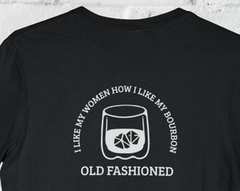 May include: Black t-shirt with a white graphic of a glass of bourbon with ice cubes and the text "I like my women how I like my bourbon OLD FASHIONED".