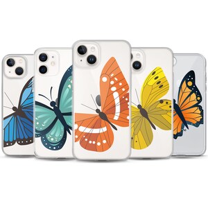 May include: Five clear smartphone cases arranged in a row, each featuring a different butterfly graphic. The designs include a blue, teal, orange, yellow, and monarch-style butterfly, all displayed with detailed wing patterns and dark bodies.