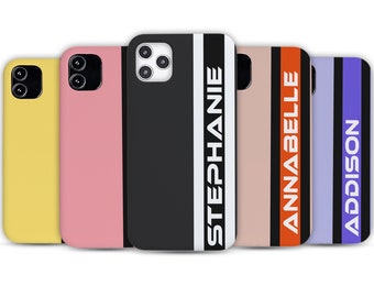 May include: Five rectangular phone cases with camera cutouts. The first is yellow, the second pink, the third black with white text reading STEPHANIE, the fourth beige with an orange stripe and white text reading ANNABELLE, and the fifth purple with a black stripe and white text reading ADDISON.