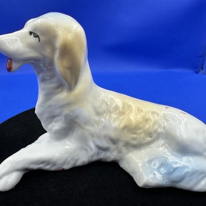 Mid 20th Century hand-decorated, Japanese made, lounging Spaniel dog figurine.