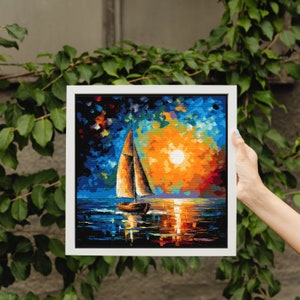 May include: A framed painting of a sailboat on a body of water with a bright orange sunset in the background. The sky is a mix of blue, purple, and orange. The sailboat is white with a brown sail.