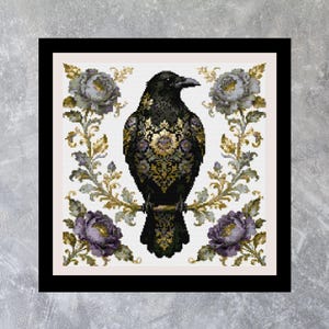 May include: Cross-stitch design featuring a black raven with ornate gold and purple detailing, perched on a branch. The raven is surrounded by gold and green floral elements and purple roses, set against a white background within a black frame.