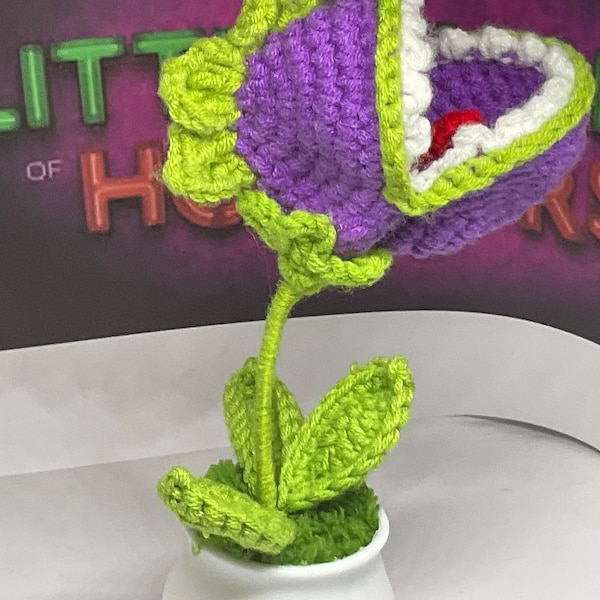 Hand knitted Audrey plant inspired by rocky horror picture show.