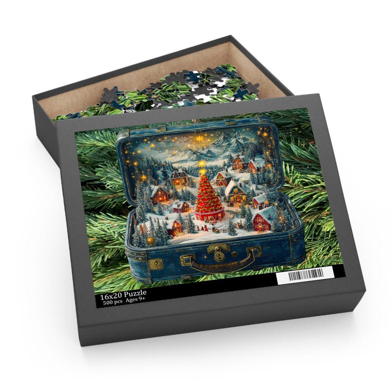 May include: A 16x20 inch puzzle in a black box, featuring a winter village scene inside a vintage blue suitcase. The puzzle shows a Christmas tree, snow-covered houses, and mountains. The box also contains puzzle pieces.