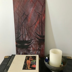 May include: A painting of two sailboats in a dark, starry sky. The sky is a deep red and purple with white stars. The sailboats are black silhouettes against the sky.