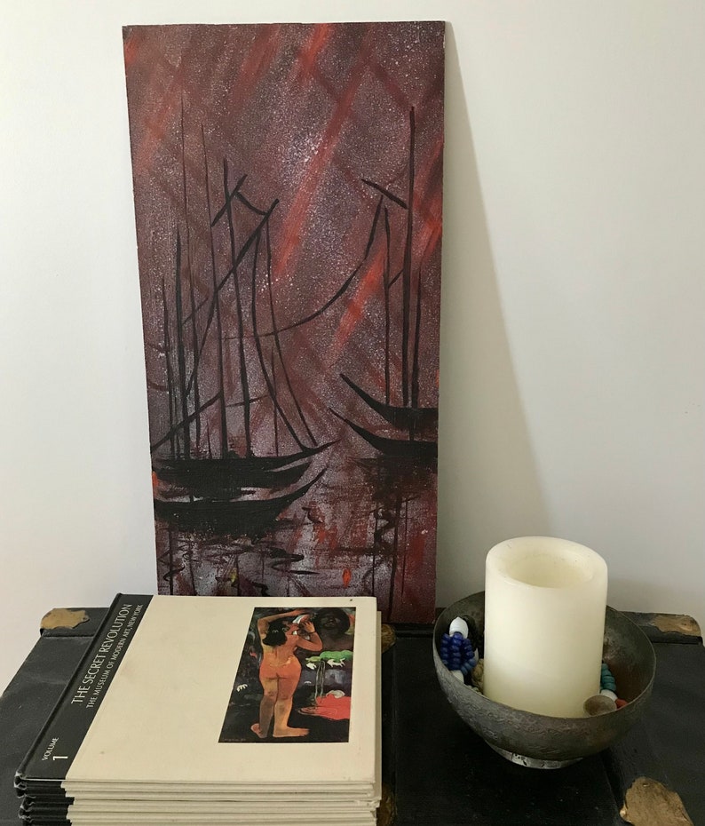 May include: A painting of two sailboats in a dark, starry sky. The sky is a deep red and purple with white stars. The sailboats are black silhouettes against the sky.