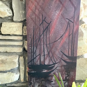 May include: Abstract painting of three sailboats in a dark, starry sky with red and white streaks of color. The sailboats are silhouetted against the sky and are reflected in the water below.