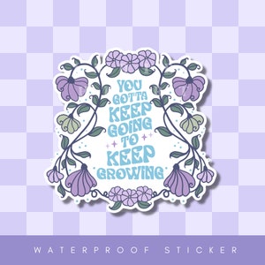 May include: A sticker with a floral design and the text "You gotta keep going to keep growing".