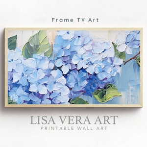 May include: A framed painting of blue hydrangeas with green leaves. The painting is on a white background and has a light wood frame. The text "LISA VERA ART PRINTABLE WALL ART" is below the frame.