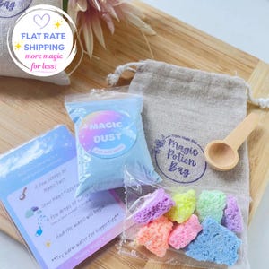 May include: A kit containing a small beige drawstring bag labelled Magic Potion Bag, a clear pouch of light blue Magic Dust, a clear pouch of multi-coloured fizzy rocks, a small wooden scoop, and an instructional card with blue text.