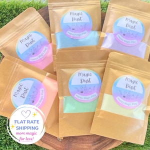 May include: Six brown paper pouches containing colourful powders. Each pouch features a circular label with a gradient background, the text Magic Dust, and the text Happy Magic Play. The powders inside are pink, blue, purple, orange, green, and yellow.