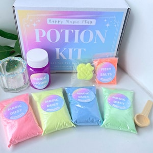 May include: A colorful potion kit with a box that reads "POTION KIT". The kit includes a bottle of purple "MAGIC LIQUID", bags of "MAGIC DUST" in pink, yellow, blue, and green, and a bag of "FIZZY SALTS". A small wooden spoon is also included.