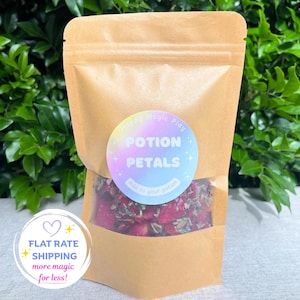 May include: A brown paper pouch with a clear window containing dried red and purple flower petals. A circular label on the front features a rainbow gradient background with the white text "Happy Magic Play POTION PETALS Add to your potion".