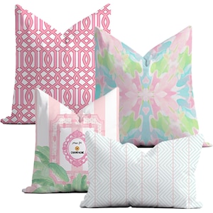 May include: Four decorative throw pillows with pink, white, and blue geometric patterns. One pillow features the text "Pour la Champagne".