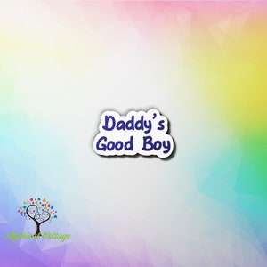 May include: A white sticker with a blue outline and the text "Daddy's Good Boy" in blue.