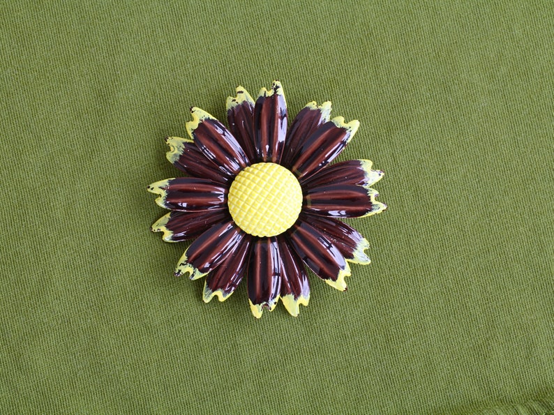 Retro 60s colorful metal flower brooch is brown daisy with yellow tips and center.