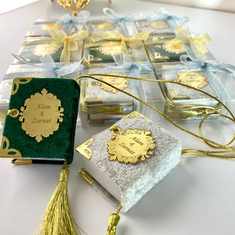 May include: A set of small, decorative, velvet-covered books with gold accents and tassels. The books are personalised with the names "Alam & Zeenat".