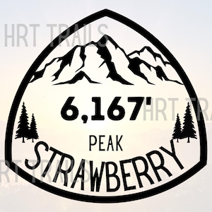 May include: Black and white graphic of a mountain peak with the text "6,167' PEAK STRAWBERRY" inside a triangular border. Two pine trees are on either side of the text. The background is a gradient of light colors.