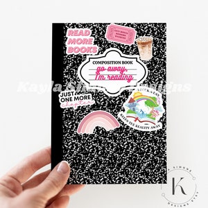 May include: A black composition notebook with a variety of colorful stickers. The stickers include a rainbow, a unicorn, a book with the text "Keeps the reality away", and a speech bubble with the text "go away, I'm reading".