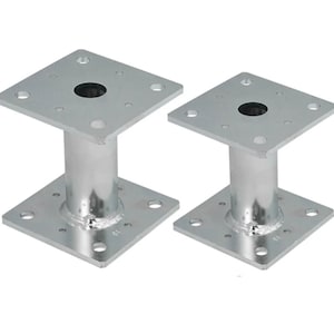 May include: Two silver metal post bases with square plates and a round hole in the center. The bases are designed for supporting posts or other structures.