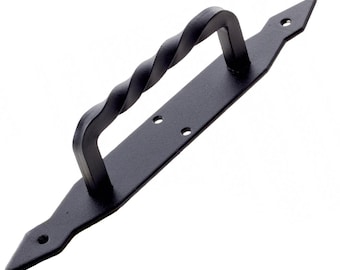 May include: Black metal door handle with a twisted design. The handle is attached to a flat plate with pointed ends.