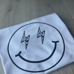 Kids Smiley Face T-Shirt: Lightning Bolt Eyes, Trendy Graphic Tee