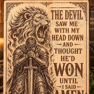 May include: A rectangular wooden plaque featuring a laser-engraved illustration of a knight kneeling with a sword and a roaring lion above. The text reads: THE DEVIL SAW ME WITH MY HEAD DOWN AND THOUGHT HE'D WON UNTIL I SAID AMEN. Decorative border.