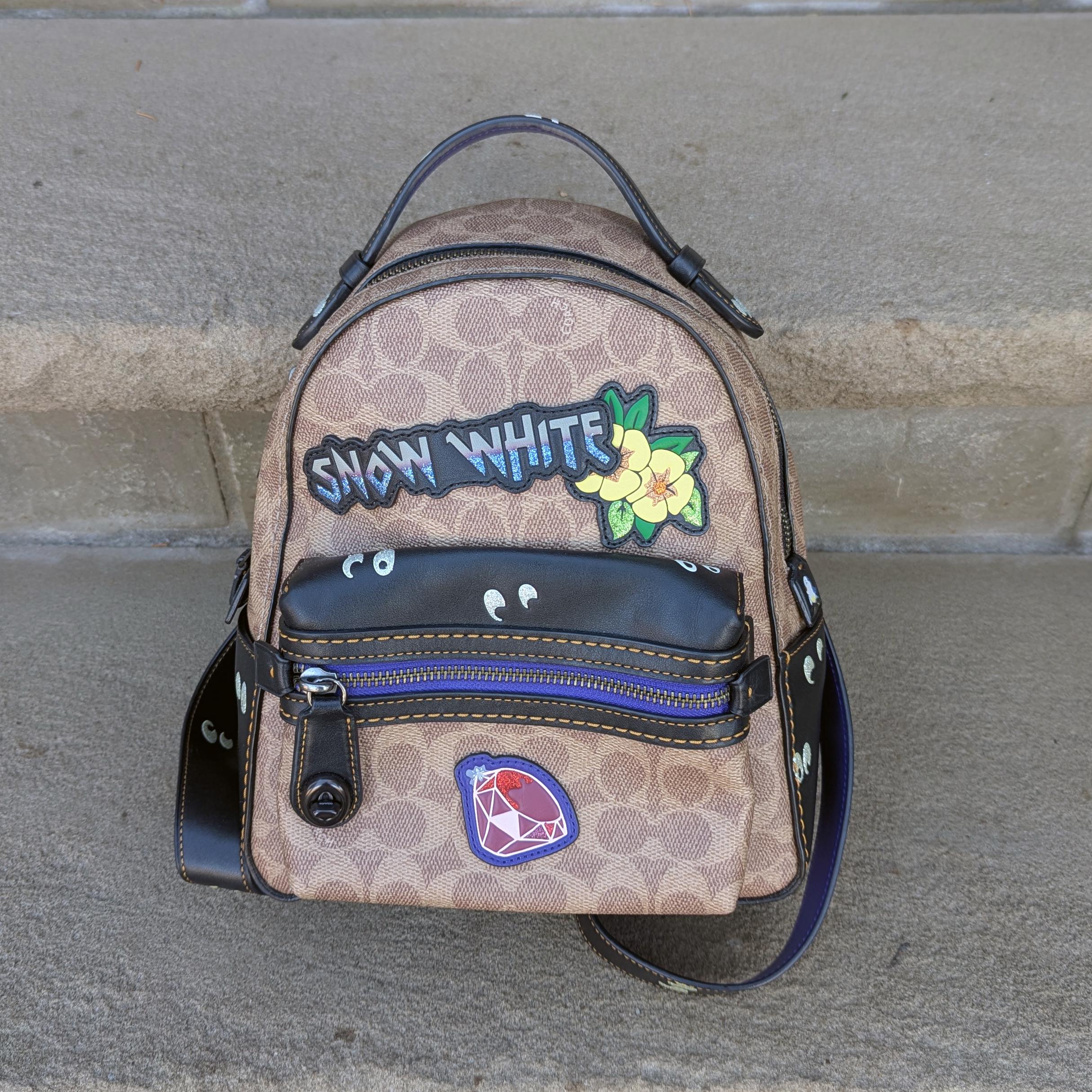 coach disney mini backpack Refined pebble leather Inside multifunction pocket Zip closure fabric lining Top handle with 2 1/2 drop Outside zip pocket Adjustable shoulder strap for crossbody wear 6 (L) x 8 (H) x 3 (W) Mickey Mouse character Coach X Disney - Snow