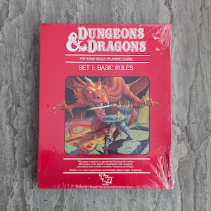 May include: A red box set of Dungeons & Dragons, a fantasy role-playing game. The cover features a dragon and a warrior in battle. The text reads "SET 1: BASIC RULES". The game is for 3 or more players, ages 10 and up.