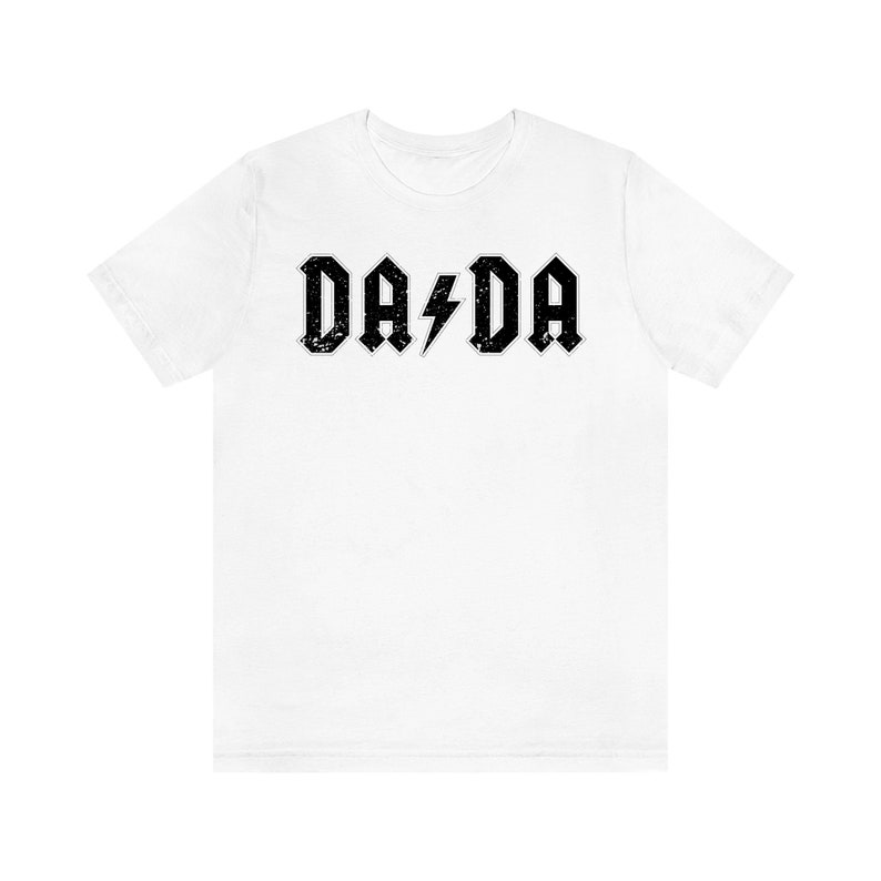 May include: White t-shirt with a black graphic print of the text "DA DA" with a lightning bolt in between the words.
