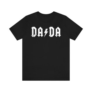 May include: Black t-shirt with a white graphic that says "DA DA" with a lightning bolt in between the words.