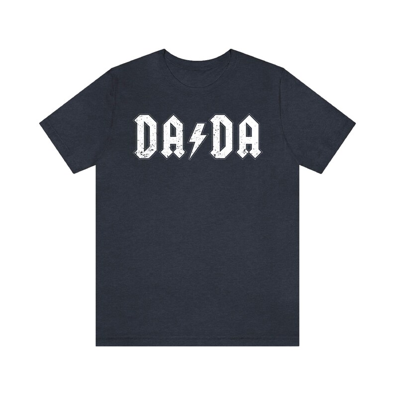 May include: A dark blue t-shirt with a white graphic that says "DA DA" with a lightning bolt in between the words.