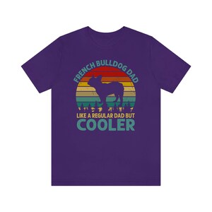 May include: Purple t-shirt with a vintage-style graphic of a French Bulldog. The graphic says "French Bulldog Dad Like a Regular Dad But Cooler".